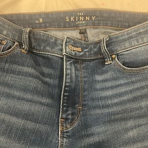 White house, black market, jeans in good condition with lace trim at the bottom.